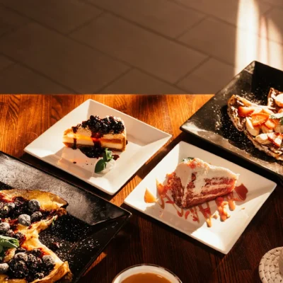 Assorted desserts including cheesecake, crepes, and cake served at Bistro 1969