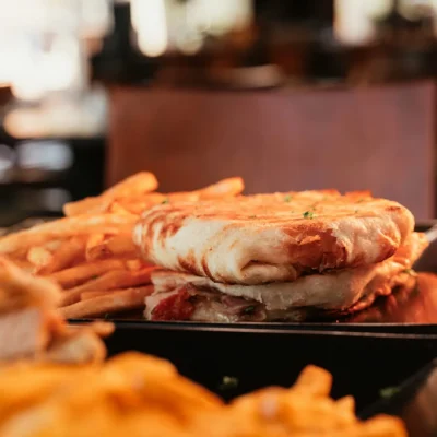 Grilled panini sandwich with crispy fries served at Bistro 1969 restaurant
