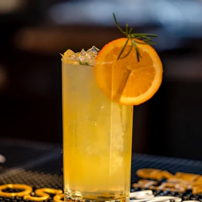 Refreshing lemon and orange cocktail with rosemary garnish served at Bistro 1969