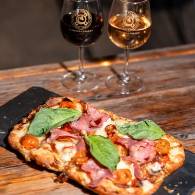 Gourmet pizza served with red and white wine at Bistro 1969