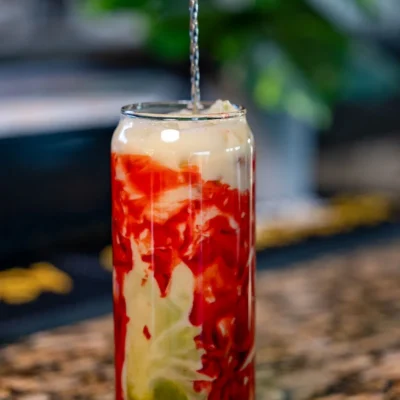 Signature layered cocktail being prepared with fresh ingredients at Bistro 1969